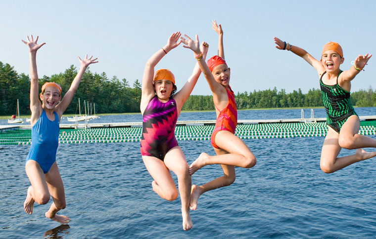 Campers jumping into the water