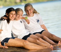 Three close friends at Tripp Lake Camp for Girls.