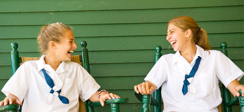 Two campers share a laugh.